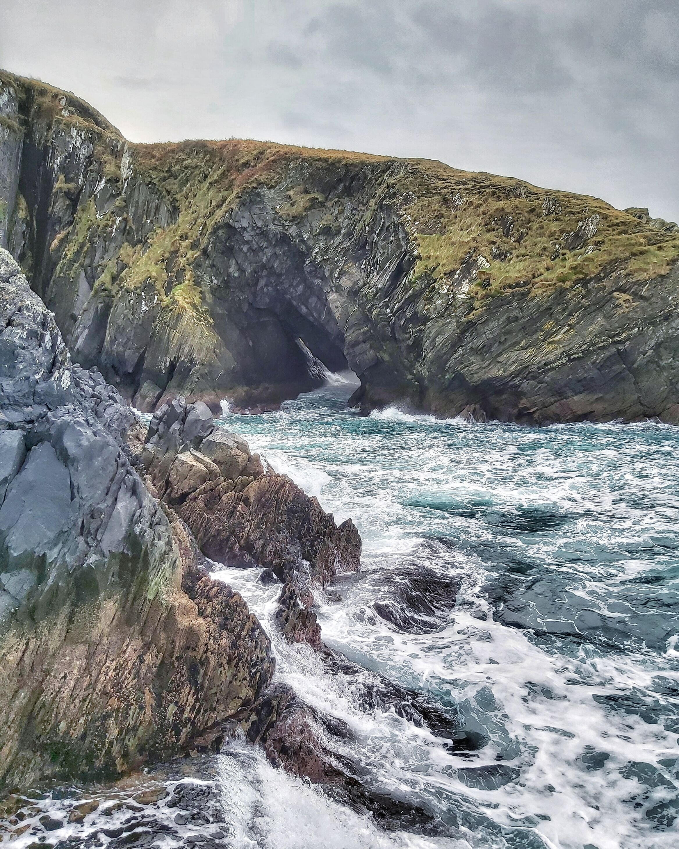 A sea cave with raging waves at Irish coast, which is a perfect place for journaling and wondering how do I change